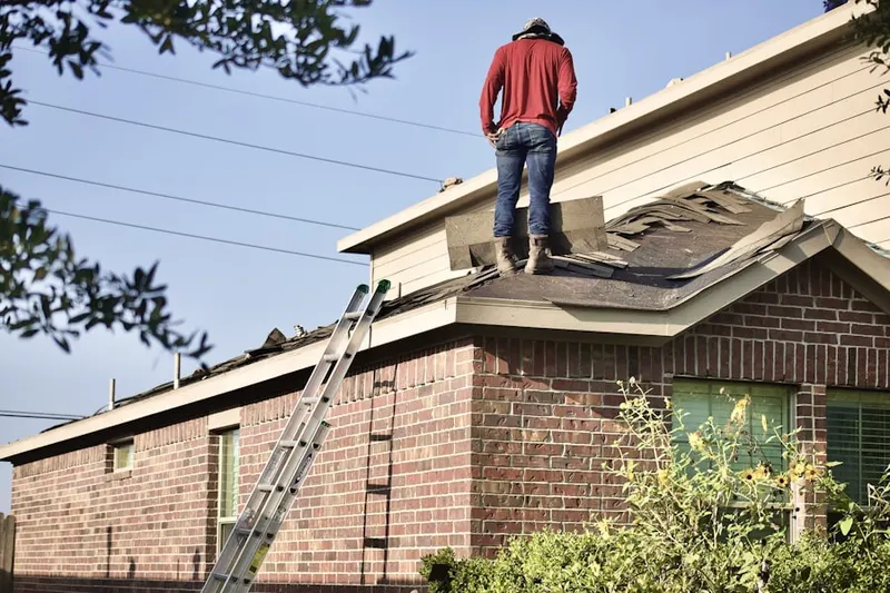 Professional roofer working on a residential roof in Pueblo West